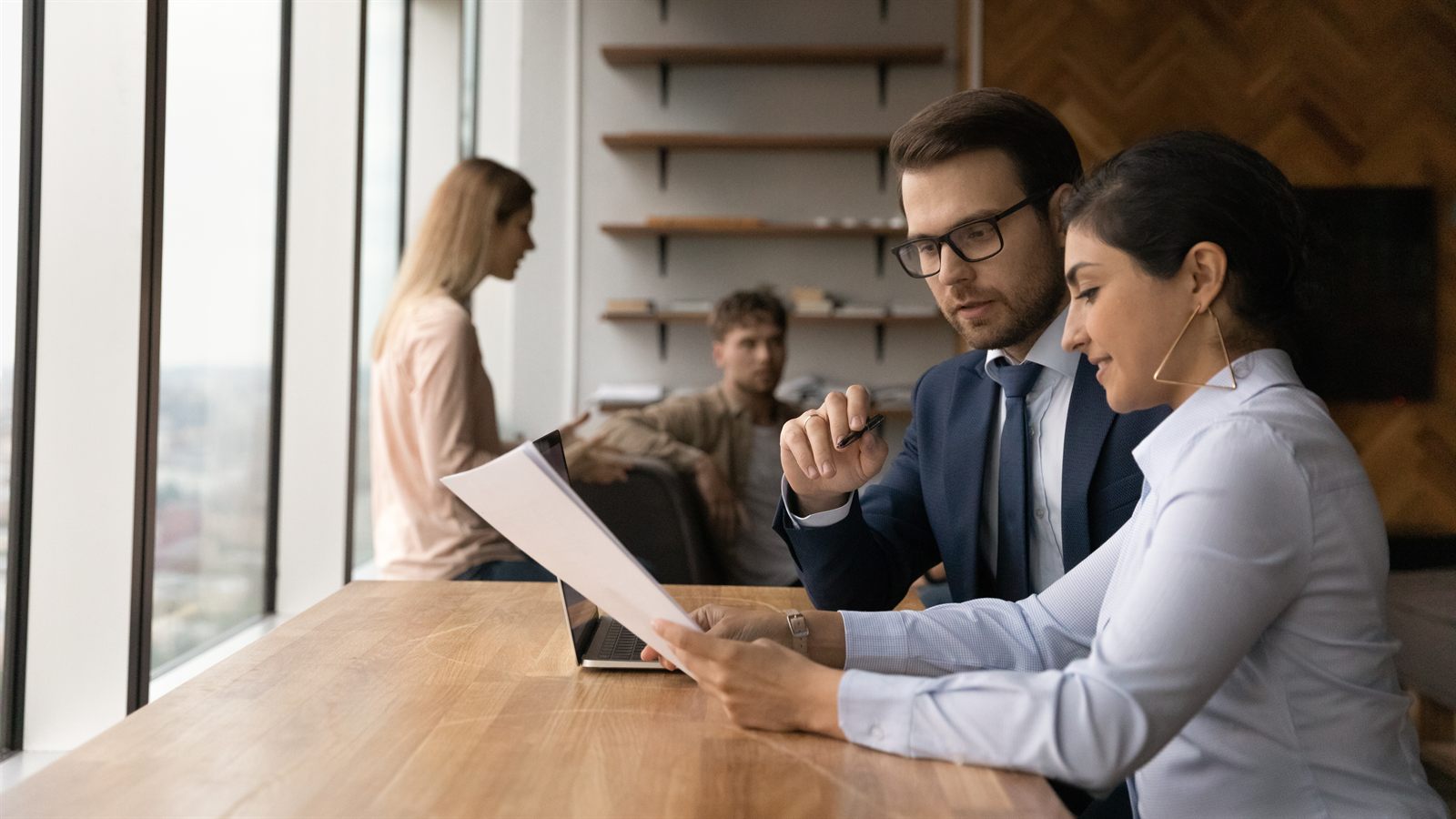 A business owner and CPA reviewing year-end financial statements