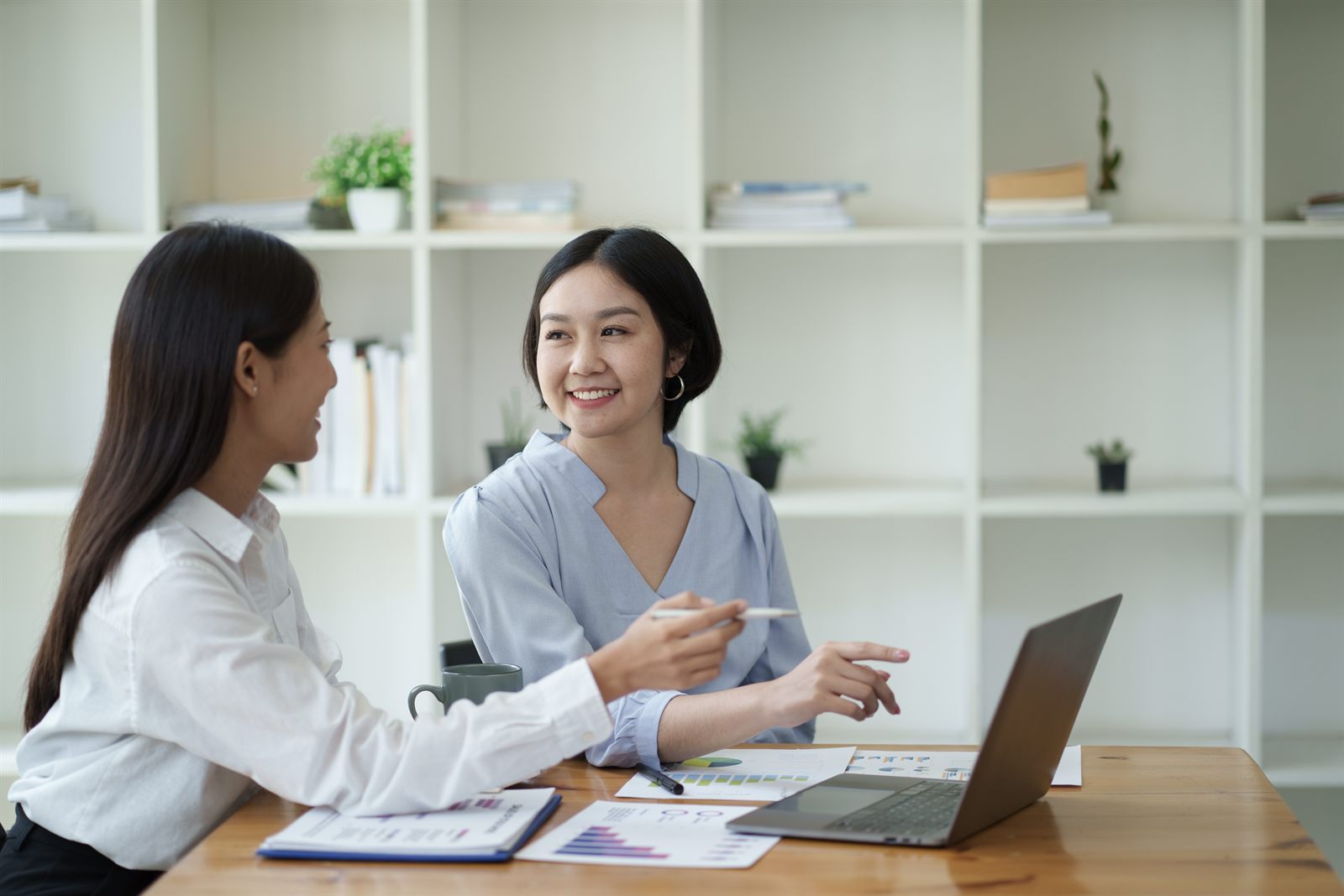 Bookkeepers reconciling monthly accounts with reports