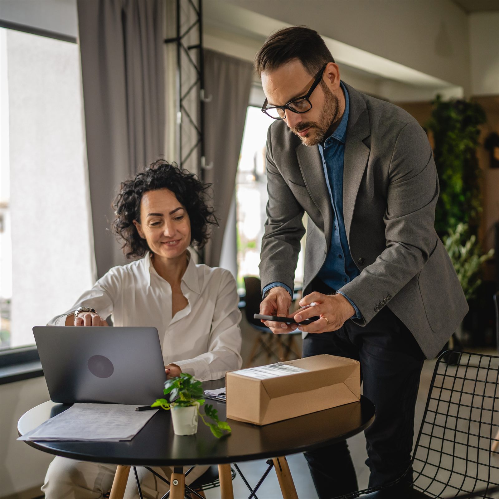 A CPA walking a client through business deductions on a laptop